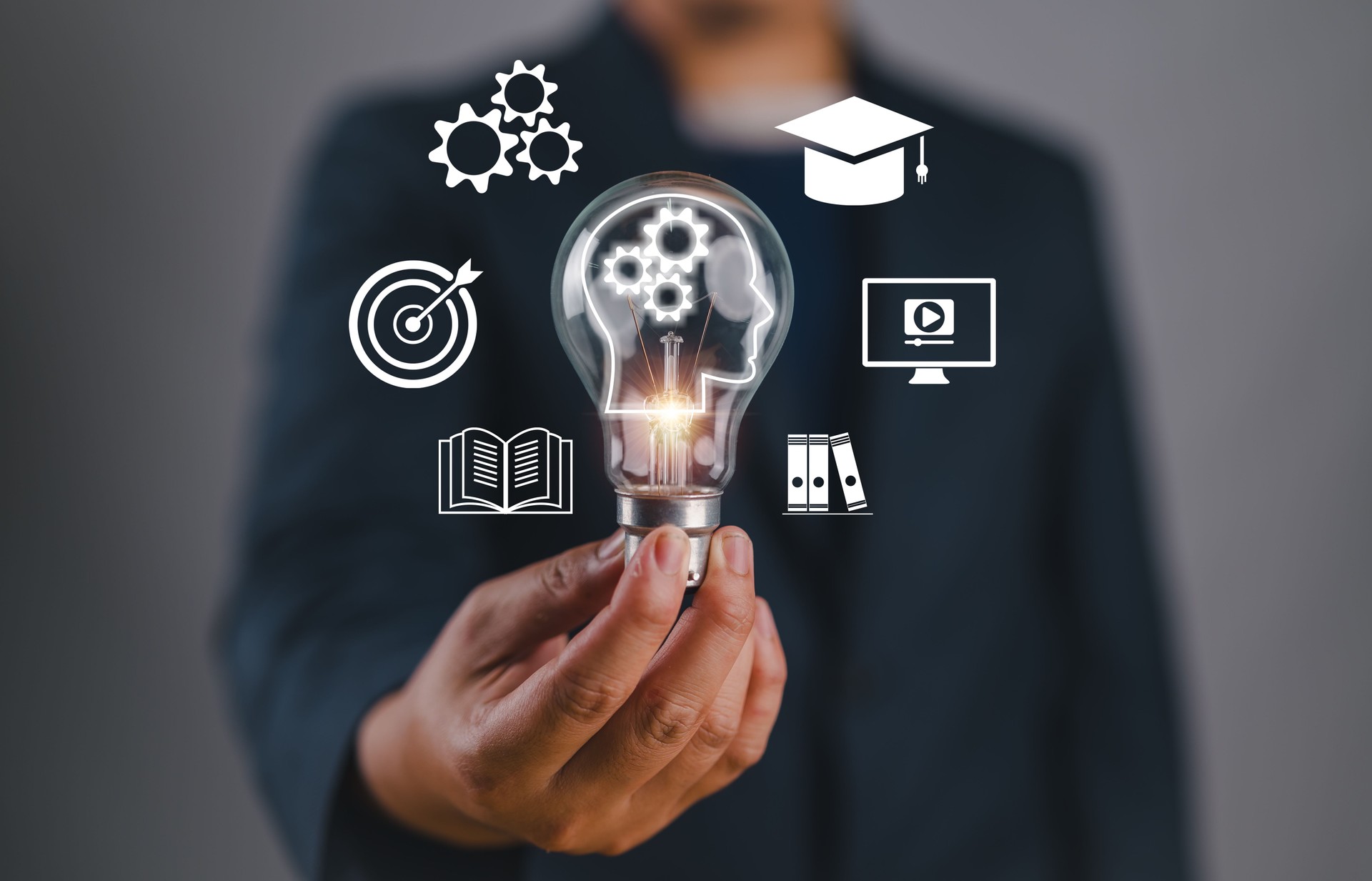 Man hand holding lightbulb with learning educate and graduation concept. study knowledge to creative thinking idea and problem solving solution, E-learning online education course degree certificate